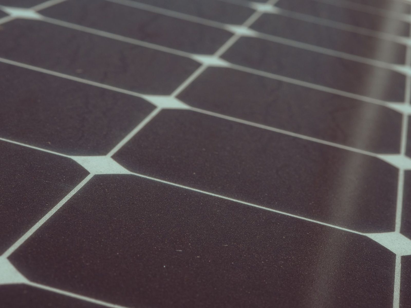 Close-up of a dark solar panel and its cell grid